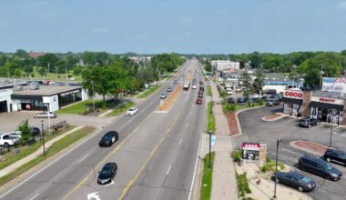 busy boulevard corridor lined with businesses and trees