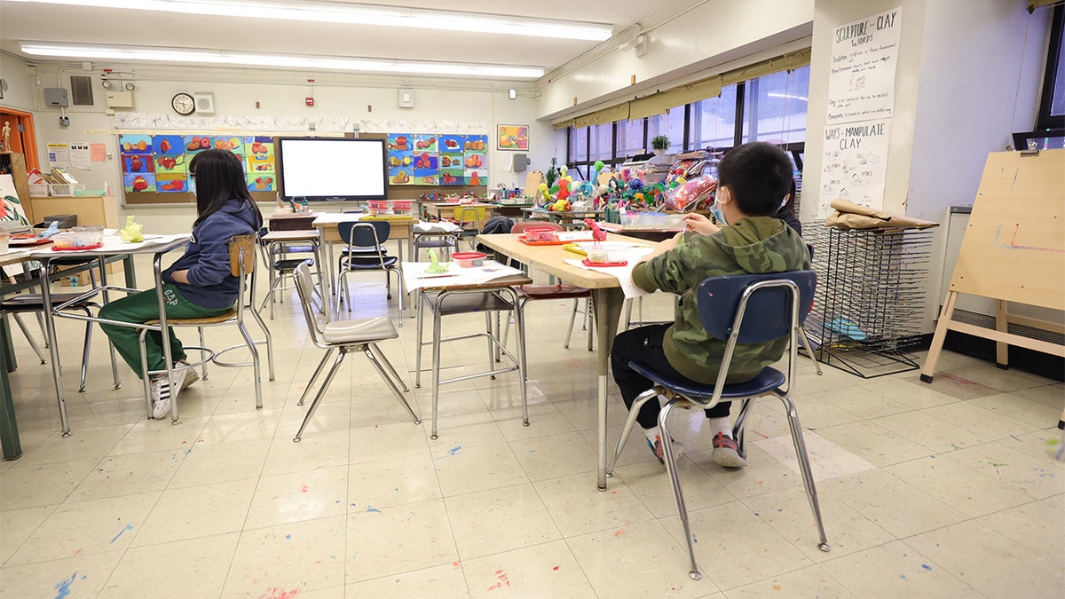 Masked students receiving an in-person art lesson at Yung Wing School P.S. 124 in New York City