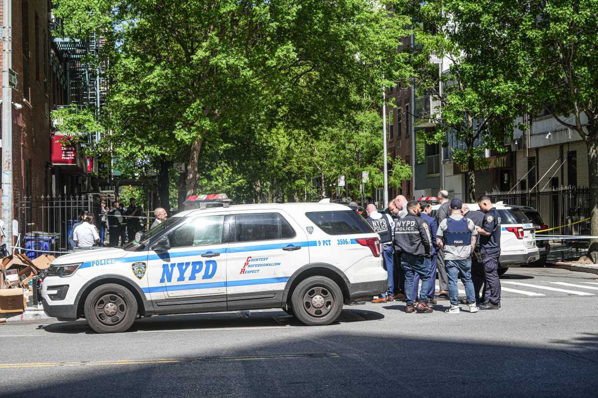 Police at Manhattan shooting scene next to NYPD vehicle