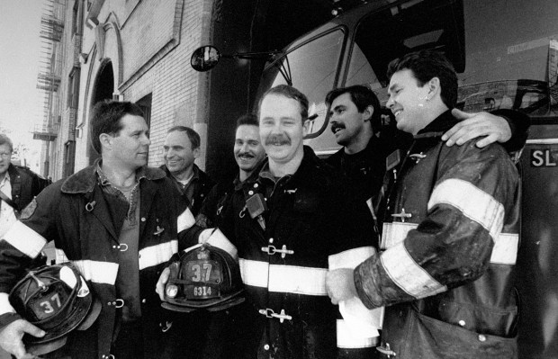 FDNY Firefighter Michael "Mickey" Conboy (center) of Ladder 37 in the Bronx is pictured surrounded by his company in 1988 after winning the New York Daily News Hero Award. (John Pedin / New York Daily News)