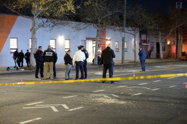 Police are seen on Burke Ave at Barnes Ave, Bronx, where several persons were shot. See orange cone markers in street where spent bullet casings were recovered. This picture was made on Wednesday, November 17, 2021.