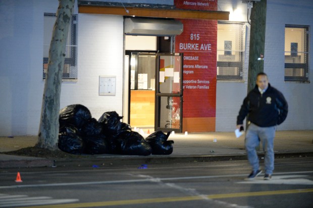 Police are seen on Burke Ave at Barnes Ave, Bronx, where several persons were shot. Numerous spent bullet casings were recovered at the scene. Several bullets shattered the lower glass door(pictured here) to a Veterans Support Center, located at 815 Burke Ave This picture was made on Wednesday, November 17, 2021.