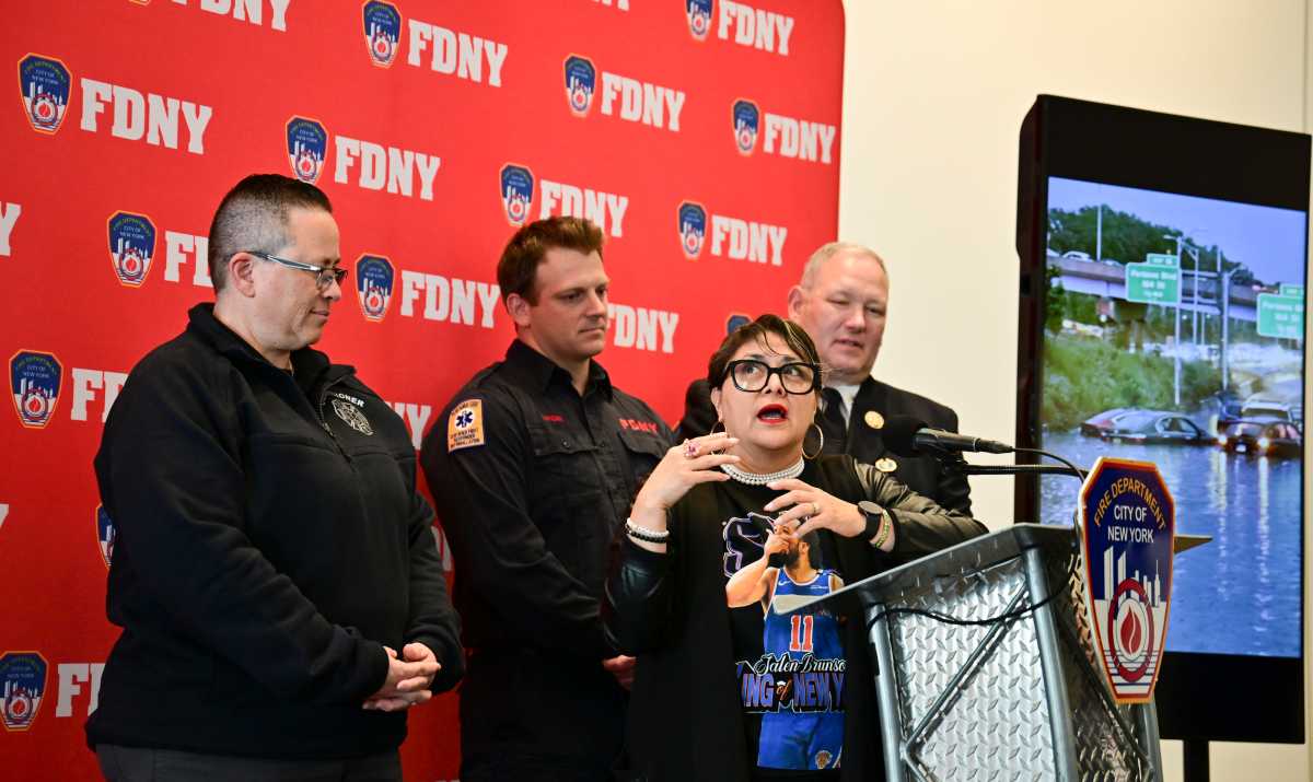 PS 81 Principal Carmen Pinto recalls being trapped in a flooded car with seconds to spare and Firefigher Travis Langan coming to her rescue with seconds to spare.