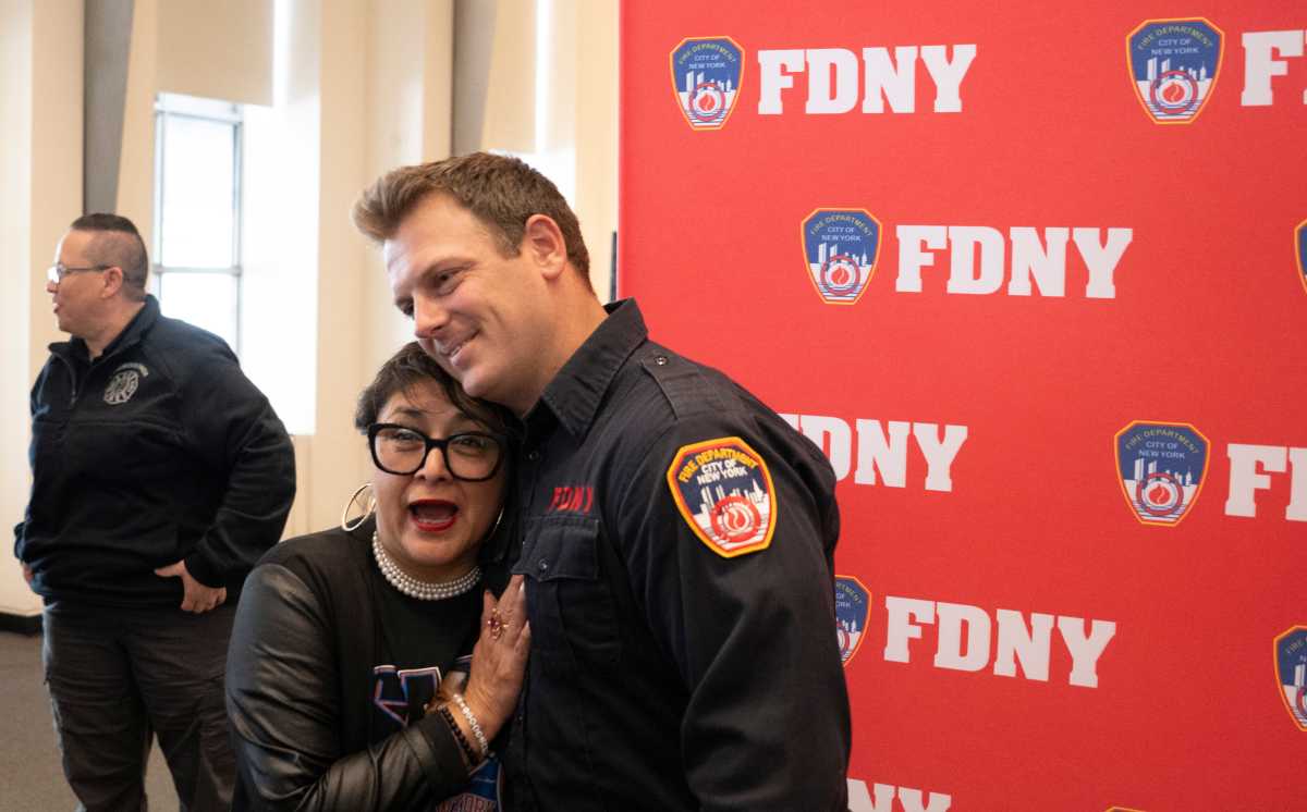 Firefighter reunites with New York City school principal who he saved during recent flood