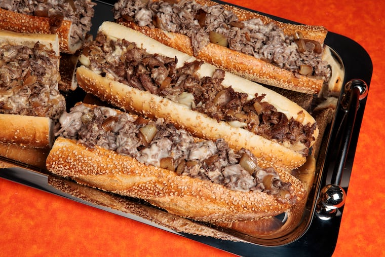Cheesesteaks from Uncle Gus’ and John’s Roast Pork at the Inquirer studio on March 5, 2025. Food styling by Emilie Fosnocht.
