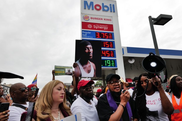 People gather at a memorial for O'Shae Sibley on Aug. 4, 2023, at the gas station where he was murdered in Brooklyn. (Photo by Spencer Platt/Getty Images)
