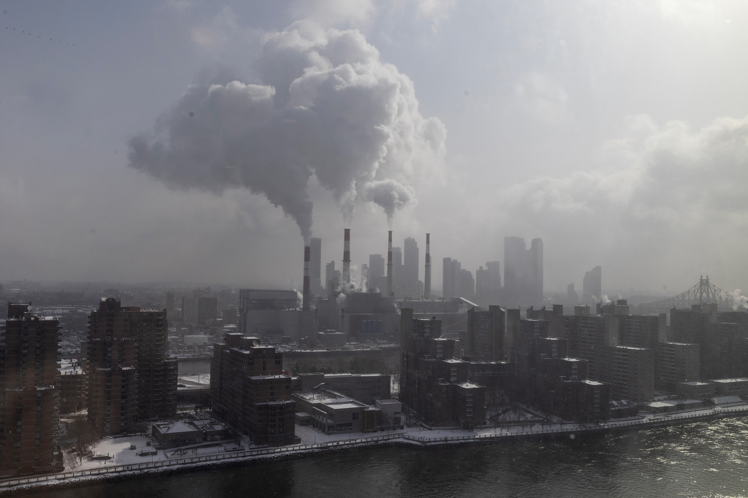 Steam rises from the smoke stacks of the gas-fired Ravenswood  Generating Station, New York City's largest power plant, on Jan. 26. Credit: Andrew Lichtenstein/Corbis via Getty Images