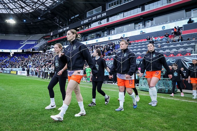 Esther González #9 of the NJ/NY Gotham FC, Savannah McCaskill #13 of the NJ/NY Gotham FC, and Kayla Duran #19 of the NJ/NY Gotham FC walk out at the start of the NWSL match between NJ/NY Gotham FC and North Carolina Courage at Sports Illustrated Stadium on March 21, 2026 in Harrison, New Jersey before possible move to Etihad Park in Queens.