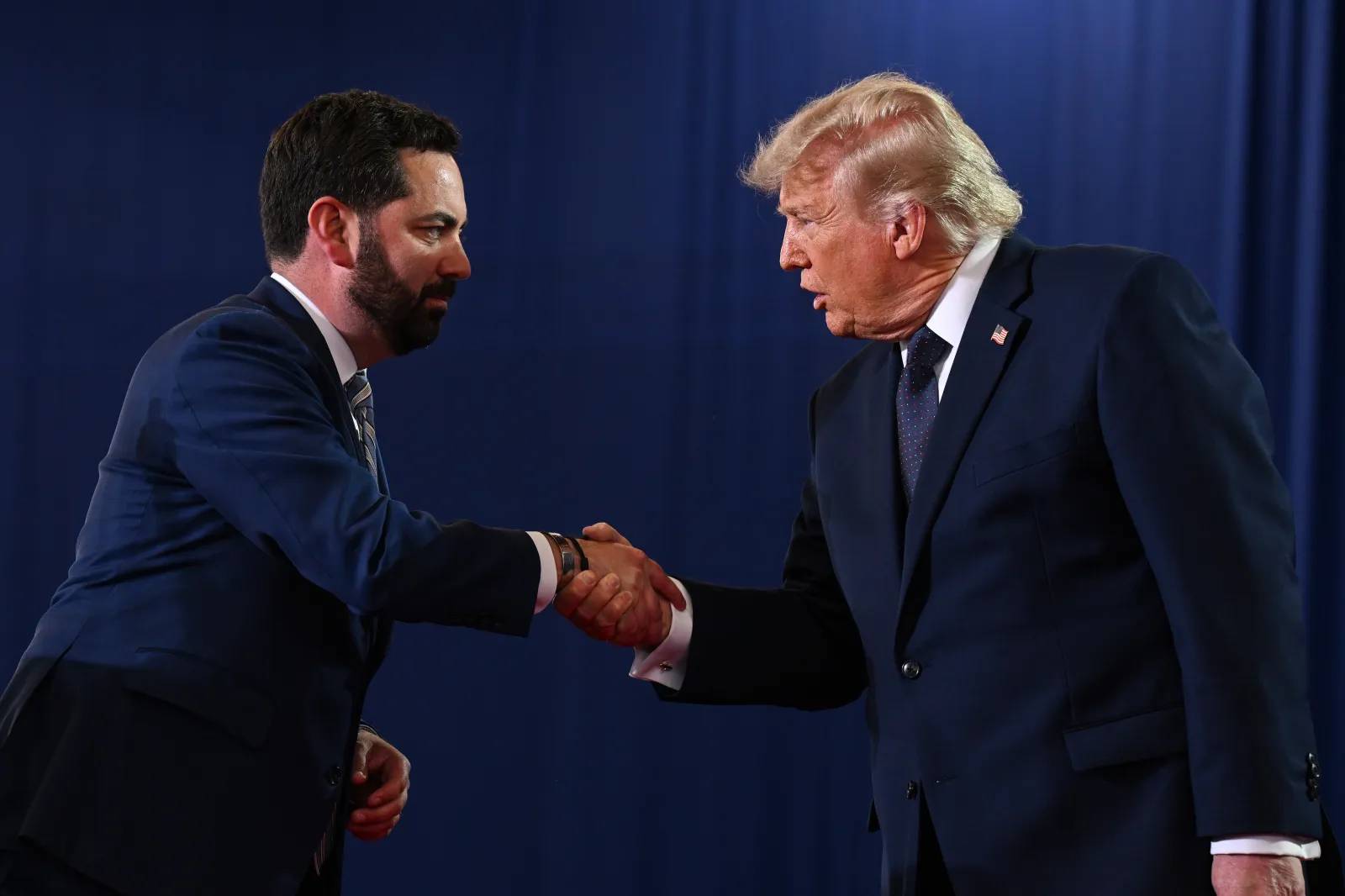 Representative Mike Lawler, a New York Republican, shakes hands with Donald Trump as he arrives to speak during a campaign and economic policy event in the Eugene Levy Fieldhouse at SUNY Rockland Community College on May 22 in Suffern, New York. (Roberto Schmidt/Getty Images)