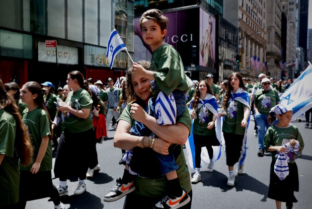 People carry Israeli flags as they participate in the Israel Day Parade in New York, on May 31, 2026. (Photo by Kena Betancur / AFP via Getty Images)
