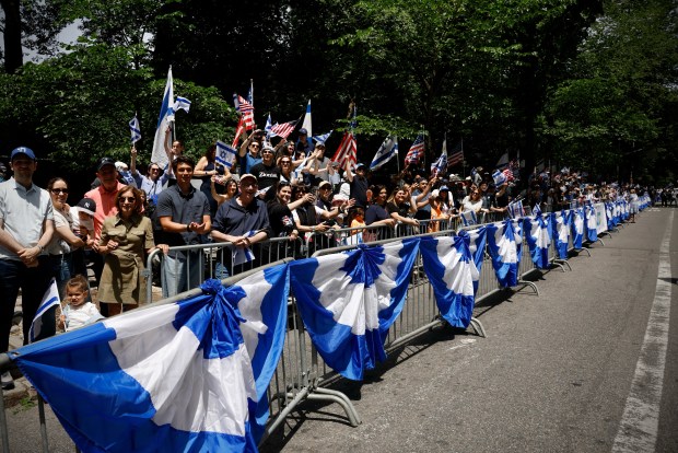 People cheer as they watch participants march during the Israel Day Parade in New York, on May 31, 2026. (Photo by Kena Betancur / AFP via Getty Images)