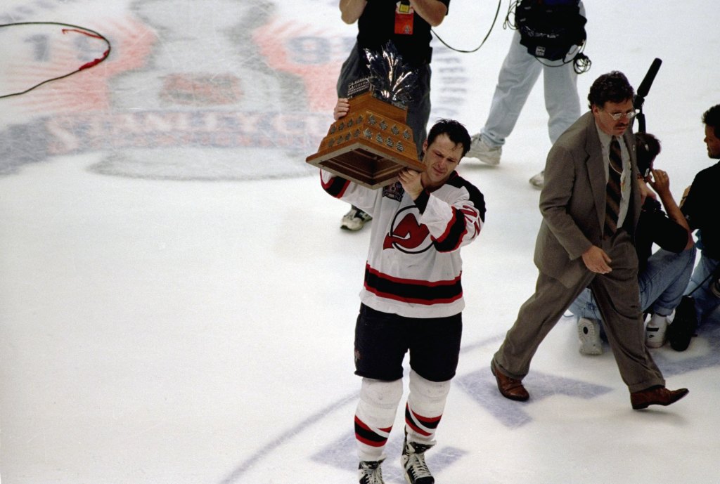 New Jersey Devils Claude Lemieux (22) victorious with Conn Smythe trophy after winning Game 4 and series vs Detroit Red Wings.