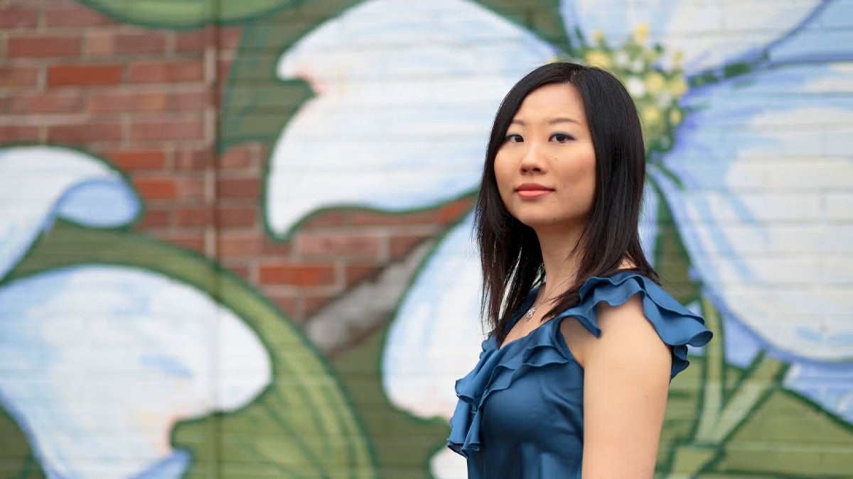 Clara Yang in front of a floral mural