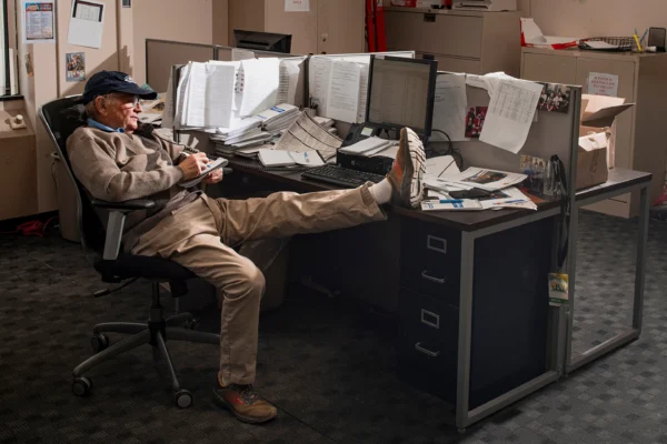 In this photo provided by Ann Hermes, sports reporter Tom Haley takes notes during an interview at his desk in The Rutland Herald newsroom on Feb. 22, 2024, in Rutland, Vermont. Photo: Ann Hermes via AP
