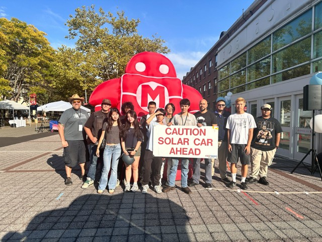 student posing for a picture outside