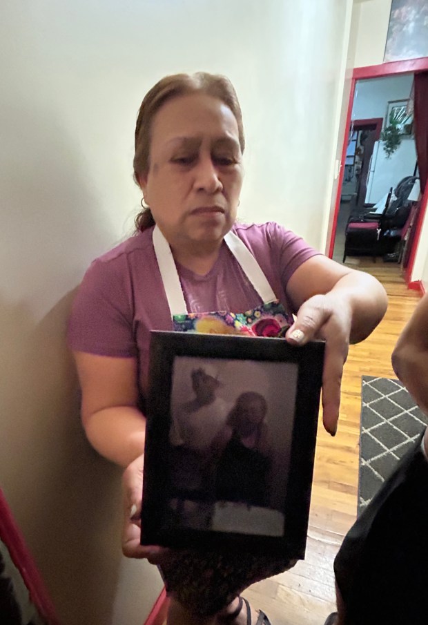 Efigenia Barrera holding a picture of her son Ramon Vasquez when he was younger. (Kerry Burke/New York Daily News)