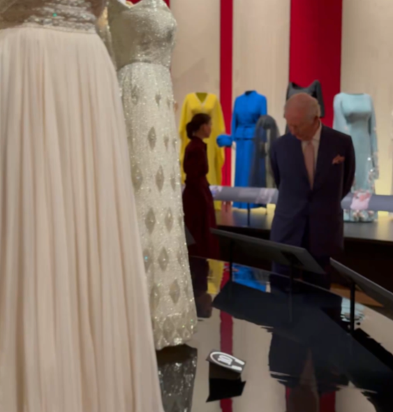 King Charles looks at clothes belonging to Queen ELizazbeth II