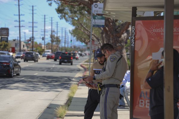 California Highway Patrol officer B. Thomas talking to a witness of the car collision. (Eleni Klostrakis| The Union).