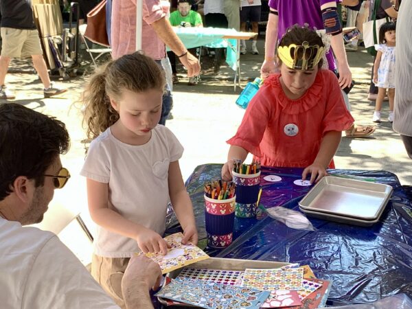 Kids concentrate as they create Disney-themed buttons. Photo: Mary Frost/Brooklyn Eagle