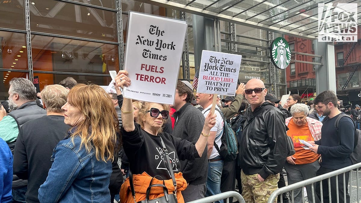 Protester holds signs