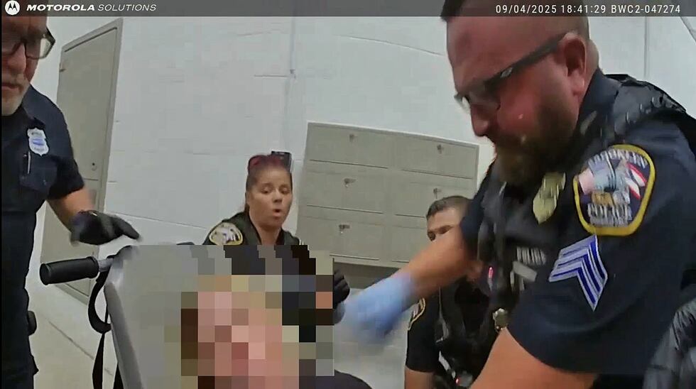 Brooklyn police officer charged with assault after punching handcuffed woman.