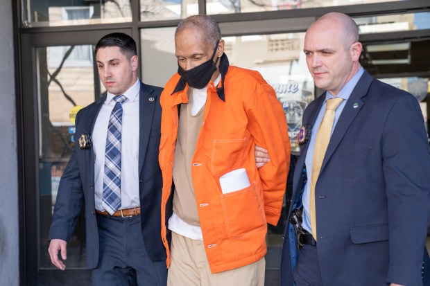 Harvey Marcelin is escorted from the 75th Precinct in Brooklyn on Monday March 14, 2022. 