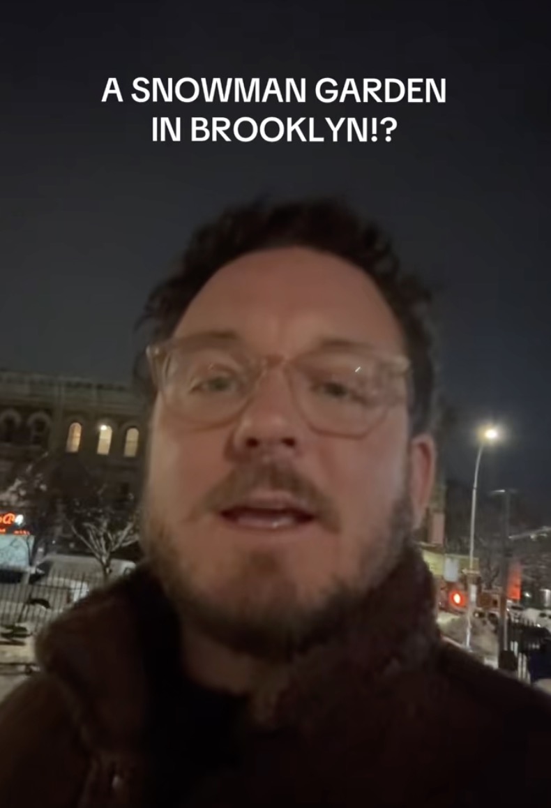 A Man Took A Stroll Through A Snowman Museum In Brooklyn man looking at snowmen
