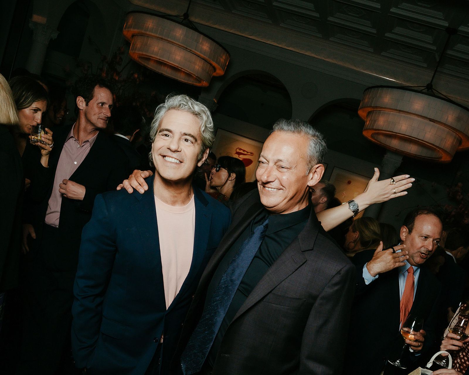 Image may contain Andy Cohen Blazer Clothing Coat Jacket Person Photobombing Face Happy Head Smile and Adult