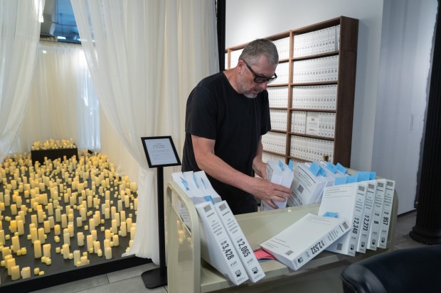 A worker organizes volumes of the Epstein files before the reading from the 3,747 bound volumes of publicly released Epstein files at the Reading Room in Tribeca Monday, May 18, 2026 in Manhattan, New York. (Barry Williams/ New York Daily News)
