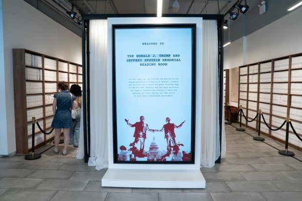 People view an exhibit in the "The Donald J. Trump and Jeffrey Epstein Reading Room" which holds copies of the 3,747 bound volumes of publicly released Epstein files at the Reading Room in Tribeca Monday, May 18, 2026 in Manhattan, New York. (Barry Williams/ New York Daily News)