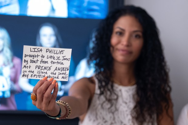 Epstein victim Lisa Phillips holds a note she going to post at an exhibit holding 3,747 bound volumes of publicly released Epstein files at the Reading Room in Tribeca Monday, May 18, 2026 in Manhattan, New York. The 24-hour live stream of people reading from the Jeffrey Epstein files was produced by Save America Movement. (Barry Williams/ New York Daily News)