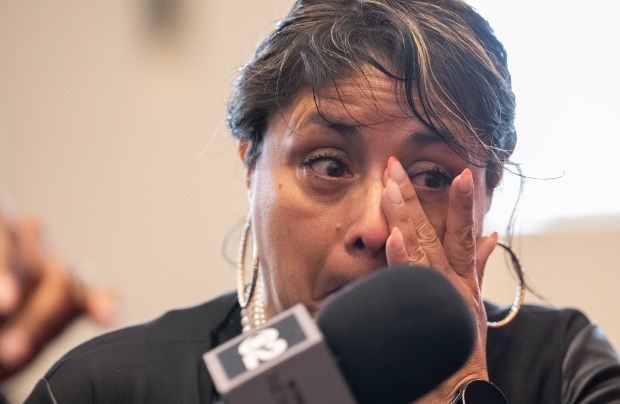 Carmen Pinto wipes away a tear while describing being trapped in her car by flood waters during a press conference at FDNY headquarters Friday, May 22, 2026 in Brooklyn, New York. (Barry Williams/ New York Daily News)