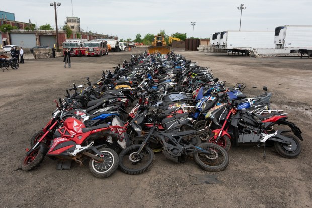 More than 200 seized illegal scooters and motorcycles are crushed by bulldozers at a DSNY facility in Staten Island, New York on Wednesday, May 13, 2026. (Gardiner Anderson / New York Daily News)