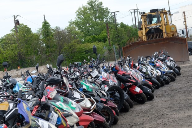 More than 200 seized illegal scooters and motorcycles are crushed by bulldozers at a DSNY facility in Staten Island, New York on Wednesday, May 13, 2026. (Gardiner Anderson / New York Daily News)
