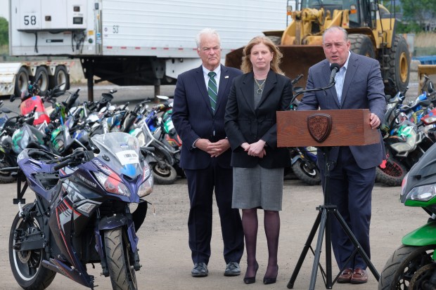 (Left to right) Staten Island District Attorney Michael McMahon, NYPD Commissioner Jessica Tisch and Staten Island Borough President Vito Fossella speak to the media as 200 seized illegal scooters and motorcycles are crushed by bulldozers at a DSNY facility in Staten Island, New York City on Wednesday, May 13, 2026. (Gardiner Anderson / New York Daily News)