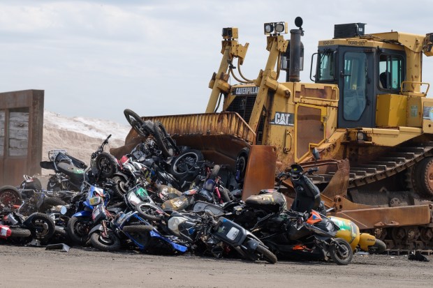 More than 200 seized illegal scooters and motorcycles are crushed by bulldozers at a DSNY facility in Staten Island, New York on Wednesday, May 13, 2026. (Gardiner Anderson / New York Daily News)