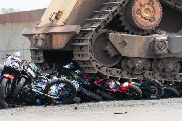 More than 200 seized illegal scooters and motorcycles are crushed by bulldozers at a DSNY facility in Staten Island, New York on Wednesday, May 13, 2026. (Gardiner Anderson / New York Daily News)