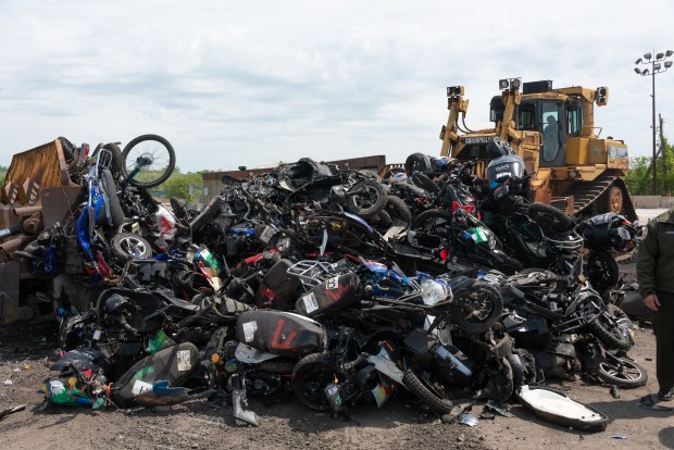 More than 200 seized illegal scooters and motorcycles are crushed by bulldozers at a DSNY facility in Staten Island, New York on Wednesday, May 13, 2026. (Gardiner Anderson / New York Daily News)