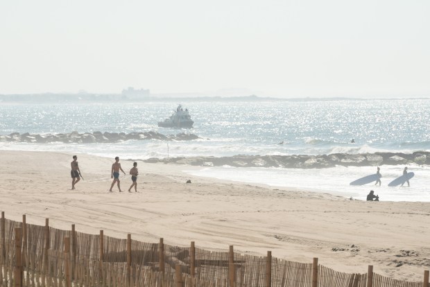 An NYPD Harbor Unit vessel continues the search for a missing 18-year-old swimmer at Rockaway Beach near Beach 73rd St. in Queens, New York City on Wednesday, May 20, 2026. 