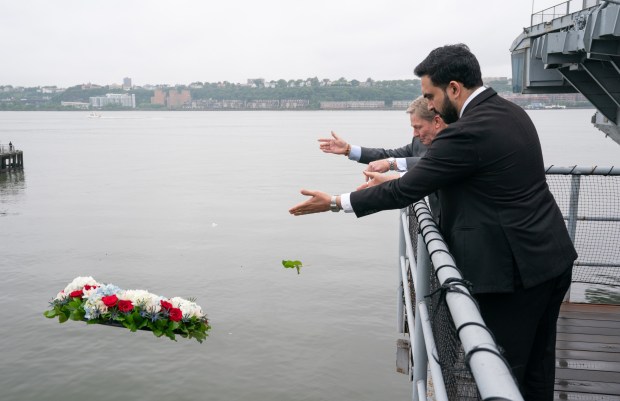 Mayor Zohran Mamdani and Ken Fisher, Co-Chairman, Intrepid Museum, toss a wreath for veterans lost in recent conflicts during the annual Memorial Day commemoration at the Intrepid Museum ceremony Monday, May 25, 2026 in Manhattan, New York. (Barry Williams/ New York Daily News)