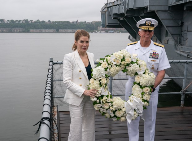 New York City Council Speaker Julie Menin and Admiral Karl Thomas, USN Commander, Fleet Forces Command, pose with a wreath honoring U.S. military personnel at the Intrepid Museum during the annual Memorial Day commemoration ceremony Monday, May 25, 2026 in Manhattan, New York. (Barry Williams/ New York Daily News)