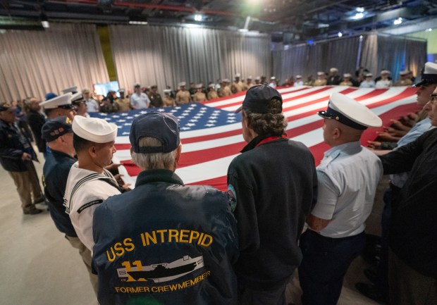 U.S. military personnel unfurl the U.S flag at the Intrepid Museum during the annual Memorial Day commemoration ceremony Monday, May 25, 2026 in Manhattan, New York. (Barry Williams/ New York Daily News)