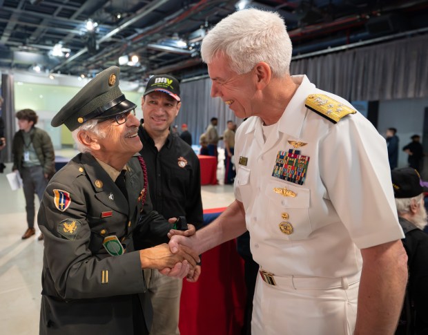 Admiral Karl Thomas, Commander United States Fleet Forces Command, greets a veteran during the annual Memorial Day commemoration ceremony at the Intrepid Museum Monday, May 25, 2026 in Manhattan, New York. (Barry Williams/ New York Daily News)