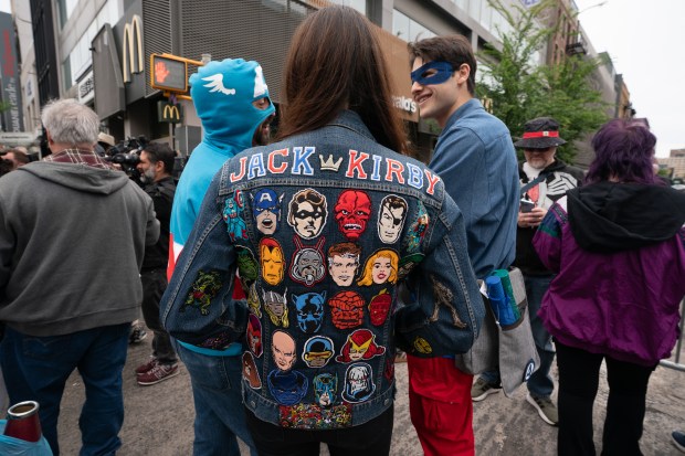 A woman wears her fan husband's Jack Kirby jacket at a street renaming for Jack Kirby Way at Essex St. and Delancey St. Monday, May 11, 2026 in Manhattan, New York. (Barry Williams/ New York Daily News)