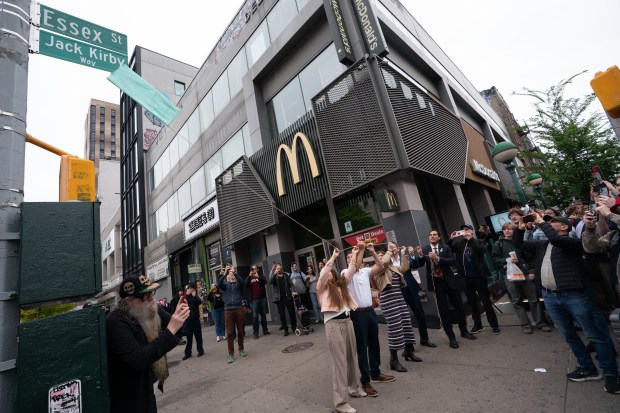 Jack Kirby's grandchildren, (L-R) Tracy Kirby, Jeremy Kirby, Jillian Kirby and Roy Schwartz, and New York City Council Member Christopher Marie, unveil a "Jack Kirby Way" sign during a street renaming at Essex St. and Delancey St. on Monday, May 11, 2026 in Manhattan, New York. (Barry Williams/ New York Daily News)