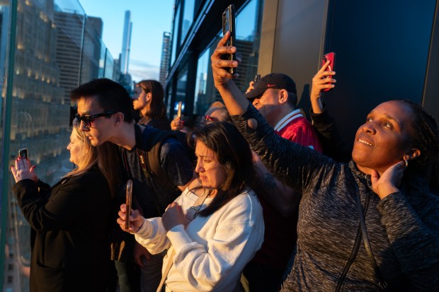 People watch 'Manhattanhenge' from One Times Square Thursday, May 28, 2026, in Manhattan, New York. (Barry Williams / New York Daily News)