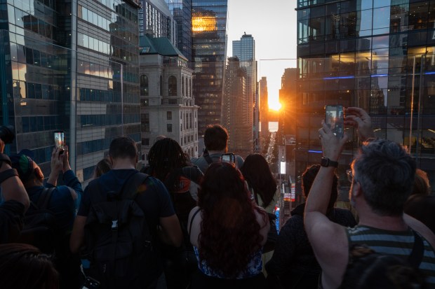 People watch 'Manhattanhenge' from One Times Square Thursday, May 28, 2026, in Manhattan, New York. (Barry Williams / New York Daily News)