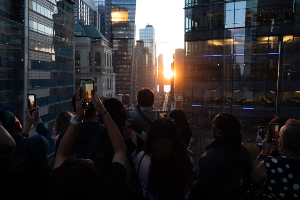 People watch 'Manhattanhenge' from One Times Square Thursday, May 28, 2026, in Manhattan, New York. (Barry Williams / New York Daily News)