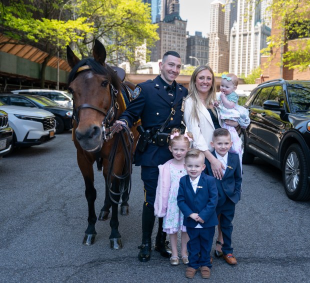 Newly promoted Det. Kyle McLaughlin poses with his family and equine partner Kelly at One Police Plaza after being promoted to detective during a ceremony Friday, May 1, 2026 in New York, New York. (Barry Williams/ New York Daily News)