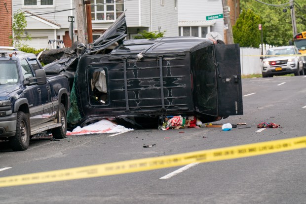 Police investigate after a man operating a black Chevy Tahoe SUV eastbound on Gannon Ave. South was killed after he lost control of the vehicle and crashed it into multiple vehicles between Ardmore Ave. and Sheraden Ave. in Staten Island on Saturday, May 2, 2026. (Theodore Parisienne / New York Daily News)
